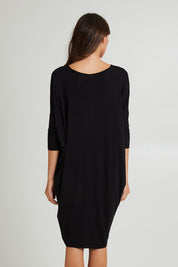 Model Madeline wearing size 10 of the Lucia Dress in colour Black (Black), from the back