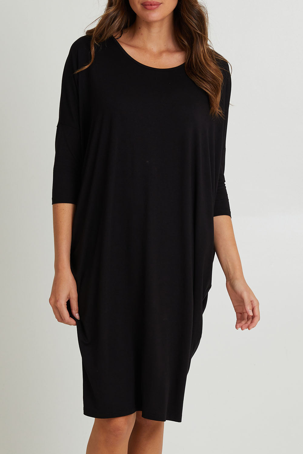 Model Madeline wearing size 10 of the Lucia Dress in colour Black (Black), from the front, cropped image