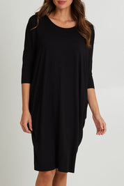 Model Madeline wearing size 10 of the Lucia Dress in colour Black (Black), from the front, cropped image