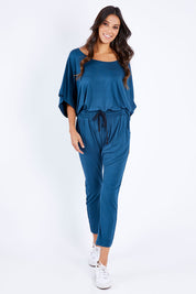 Model Vitoria wearing size 10 of the Hamilton Pant in colour Teal (Green), from the front, showing the whole outfit