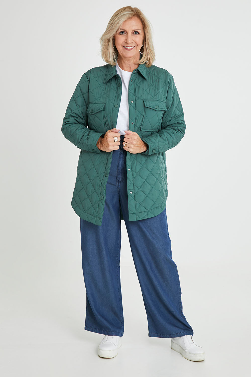 Model Sandy wearing size S of the Pasadena Quilted Shacket in colour Silverfern (Green), from the front, showing the whole outfit