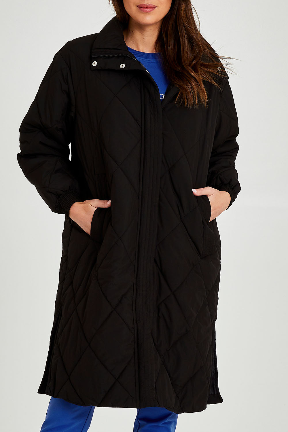 Model Madeline wearing size 10 of the Tribeca Puffer Jacket in colour Black (Black), from the front, cropped image
