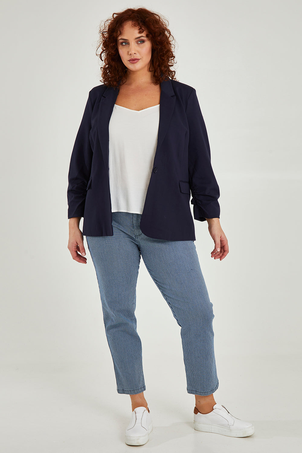 Model Maddy wearing size 16 of the Merci Ponte Blazer in colour Peonynavy (Blue), from the front, showing the whole outfit