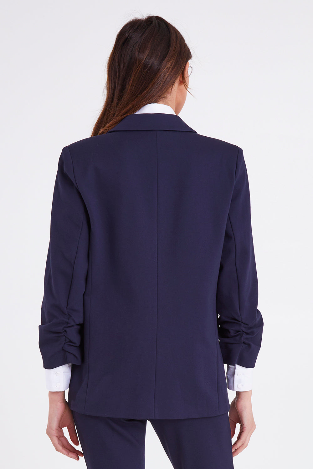 Model Madeline wearing size 10 of the Merci Ponte Blazer in colour Peonynavy (Blue), from the back