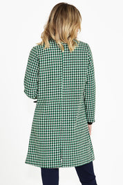 A model wearing the Wanda Coat in colour Greenhound (Green), from the back
