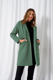 A model wearing the Wanda Coat in colour Greenhound (Green), from the front, showing the whole outfit