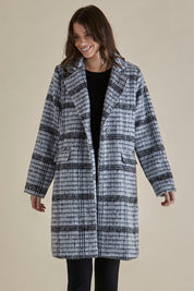 A model wearing the Wanda Coat in colour Monochrome (Grey), from the back