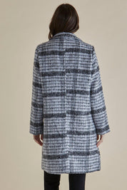 A model wearing the Wanda Coat in colour Monochrome (Grey), from the back
