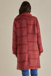 A model wearing the Wanda Coat in colour Rouge (Red), from the back