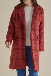 A model wearing the Wanda Coat in colour Rouge (Red), from the front, cropped image