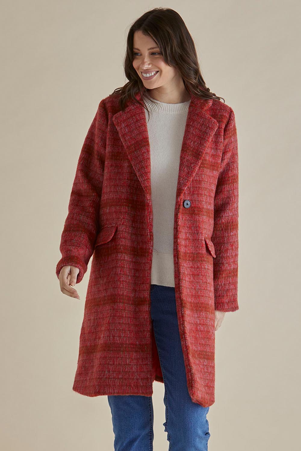 A model wearing the Wanda Coat in colour Rouge (Red), from the front, cropped image