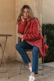 A model wearing the Wanda Coat in colour Rouge (Red), from the front, showing the whole outfit