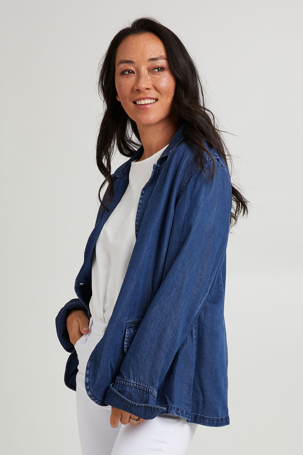 Model Katie wearing size 10 of the Melba Denim Blazer in colour Drkrinse (Blue), from the front, cropped image
