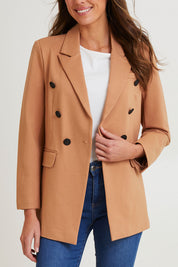 Model Madeline wearing size 10 of the Kaisley Blazer in colour Tan, from the front, cropped image