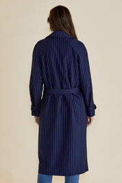 A model wearing the Mayla Duster in colour Bluepinstr (Blue), from the back