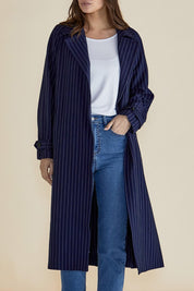 A model wearing the Mayla Duster in colour Bluepinstr (Blue), from the front, cropped image