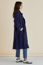 A model wearing the Mayla Duster in colour Bluepinstr (Blue), from the front, showing the whole outfit
