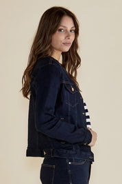 A model wearing the Cindy Collarless Denim Jacket in colour Ink (Blue), from the front, cropped image