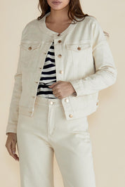 A model wearing the Cindy Collarless Denim Jacket in colour Offwhite (White), from the front, cropped image