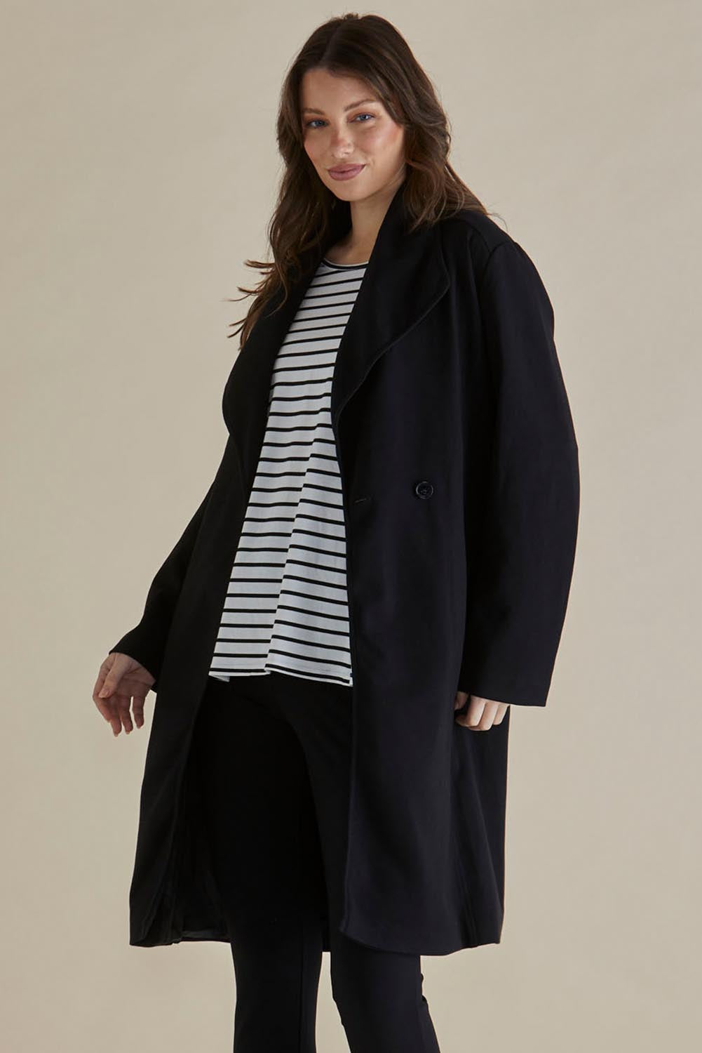 A model wearing the Gabriel Coat in colour Black (Black), from the front, cropped image