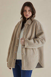 A model wearing the Teddy Jacket in colour Latte, from the back
