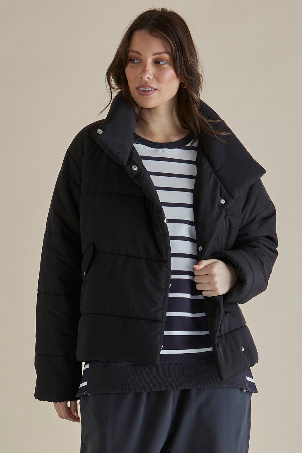 A model wearing the Presley Puffer Jacket in colour Black (Black), from the front, cropped image