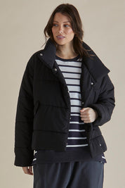 A model wearing the Presley Puffer Jacket in colour Black (Black), from the front, cropped image