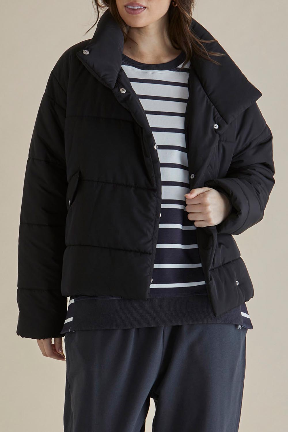 A model wearing the Presley Puffer Jacket in colour Black (Black), from the front, cropped image