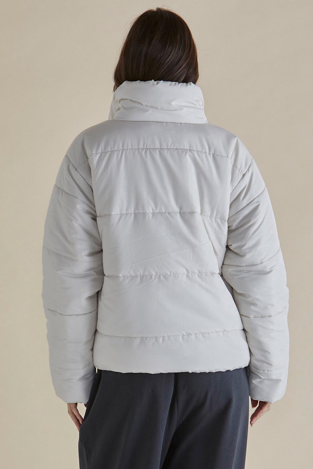 A model wearing the Presley Puffer Jacket in colour Pearl, from the back