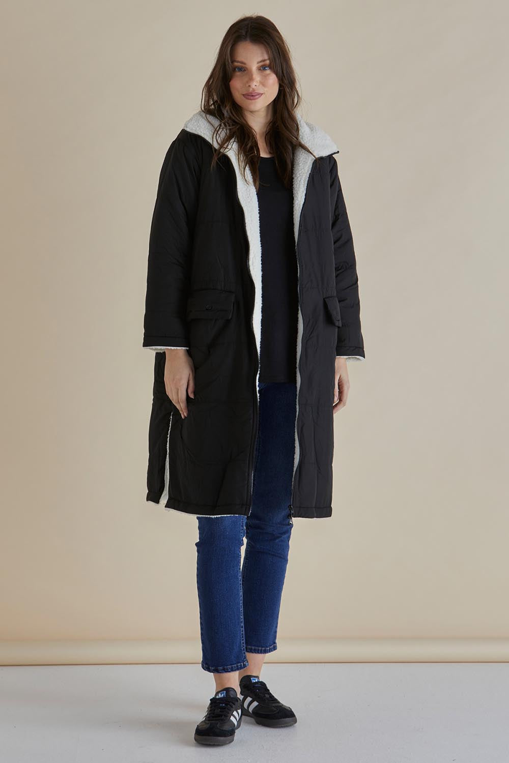 A model wearing the Valkyrie Puffer Jacket in colour Black (Black), from the front, showing the whole outfit