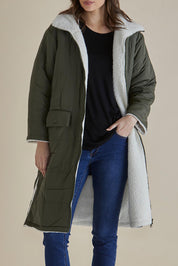 A model wearing the Valkyrie Puffer Jacket in colour Darkgreen (Green), from the front, cropped image