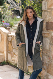 A model wearing the Valkyrie Puffer Jacket in colour Darkgreen (Green), from the front, showing the whole outfit