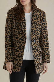A model wearing the Prague Coat in colour Animal, from the front, cropped image