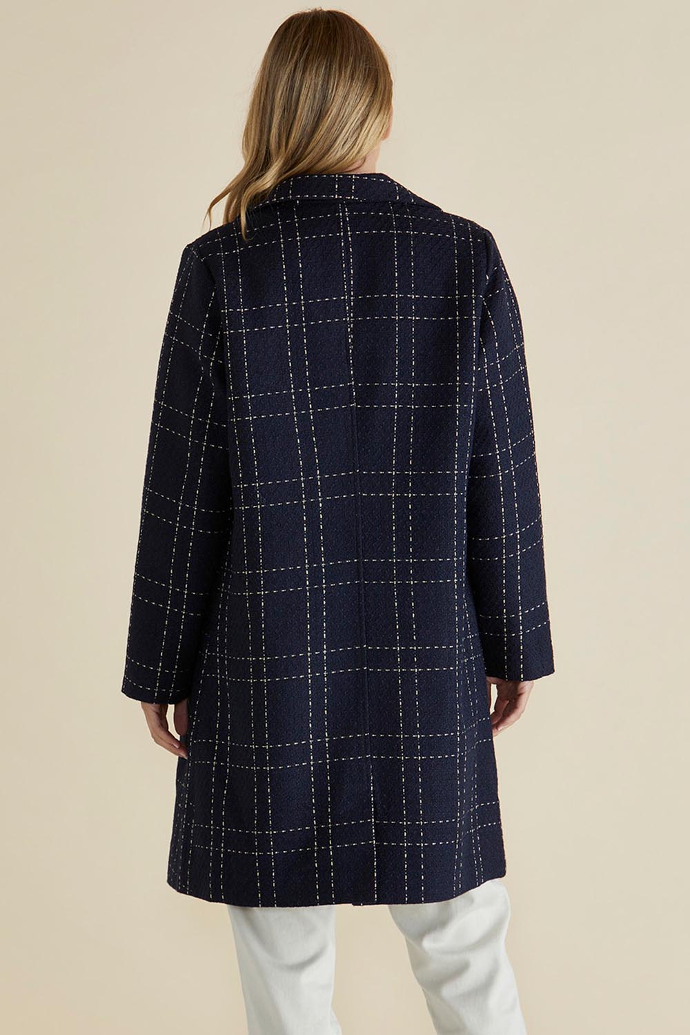 A model wearing the Genevieve Coat in colour Navycheck (Blue), from the back
