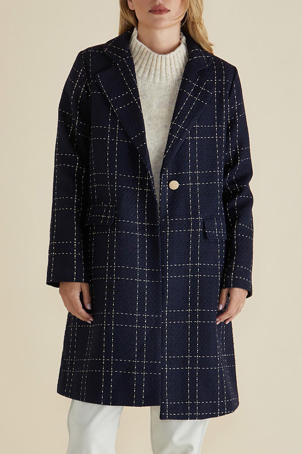 A model wearing the Genevieve Coat in colour Navycheck (Blue), from the front, cropped image
