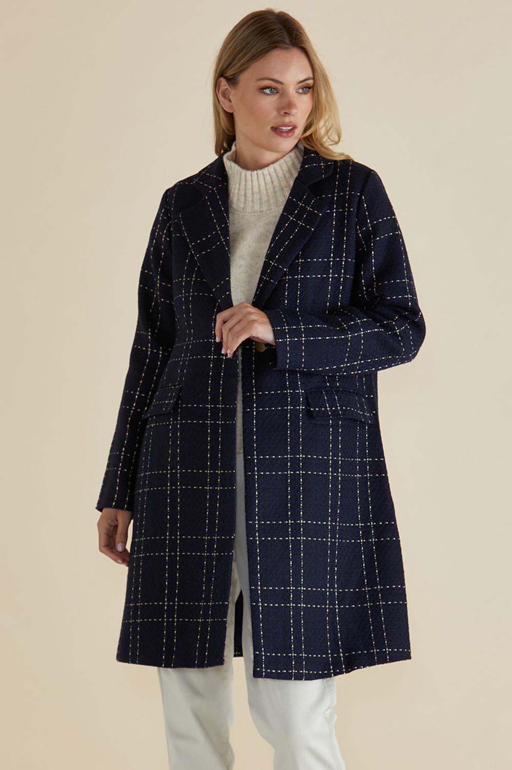 A model wearing the Genevieve Coat in colour Navycheck (Blue), from the front, cropped image