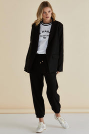 A model wearing the Portland Blazer in colour Black (Black), from the front, showing the whole outfit