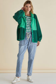 A model wearing the Franklin Fleecy Jacket in colour Green (Green), from the front, showing the whole outfit