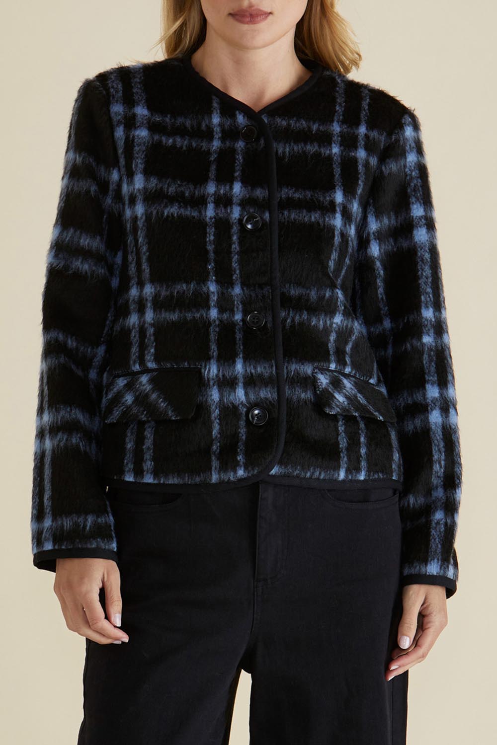 A model wearing the Charlie Check Coat in colour Bluecheck (Blue), from the front, cropped image