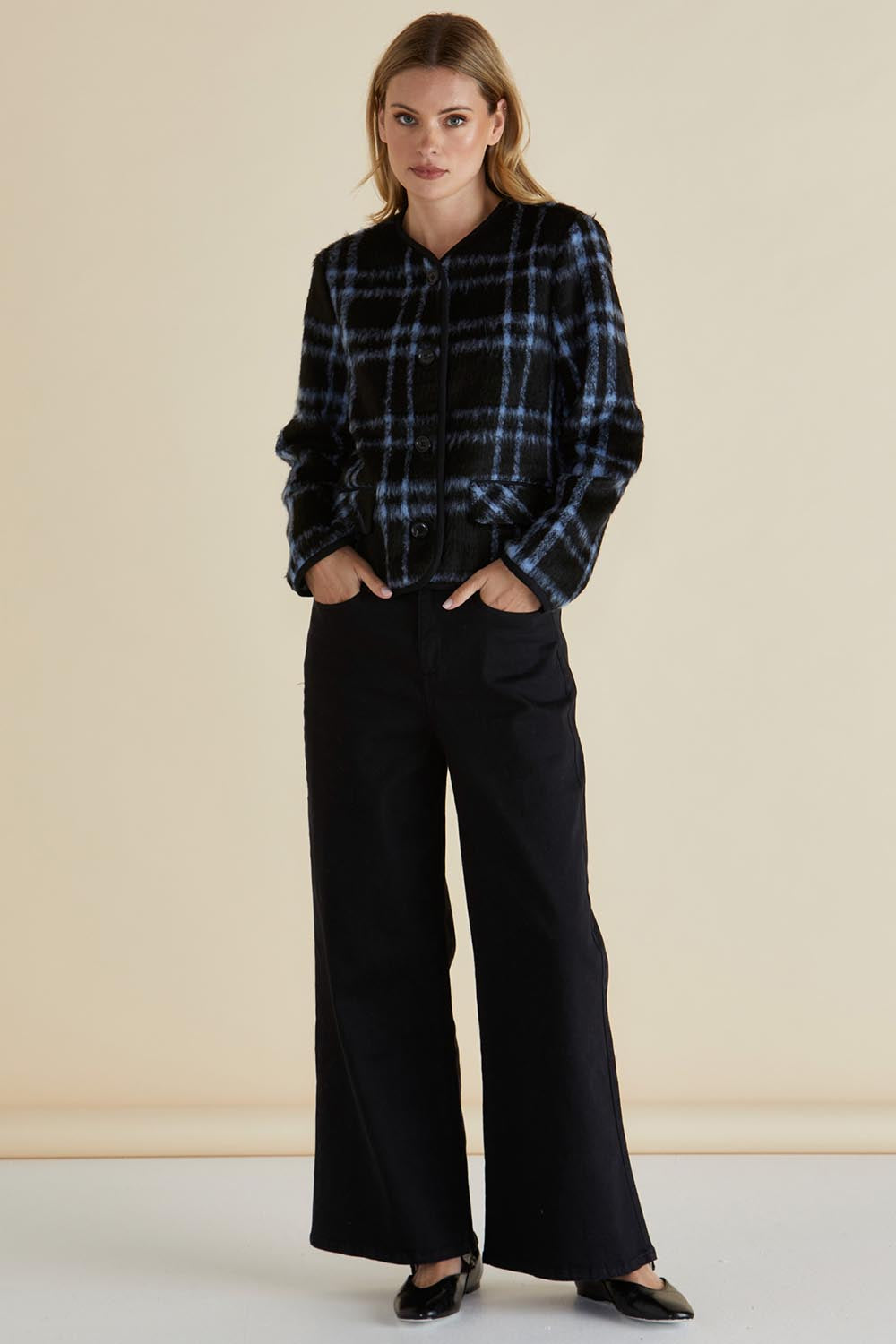 A model wearing the Charlie Check Coat in colour Bluecheck (Blue), from the front, showing the whole outfit