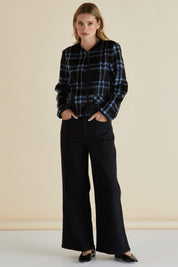 A model wearing the Charlie Check Coat in colour Bluecheck (Blue), from the front, showing the whole outfit