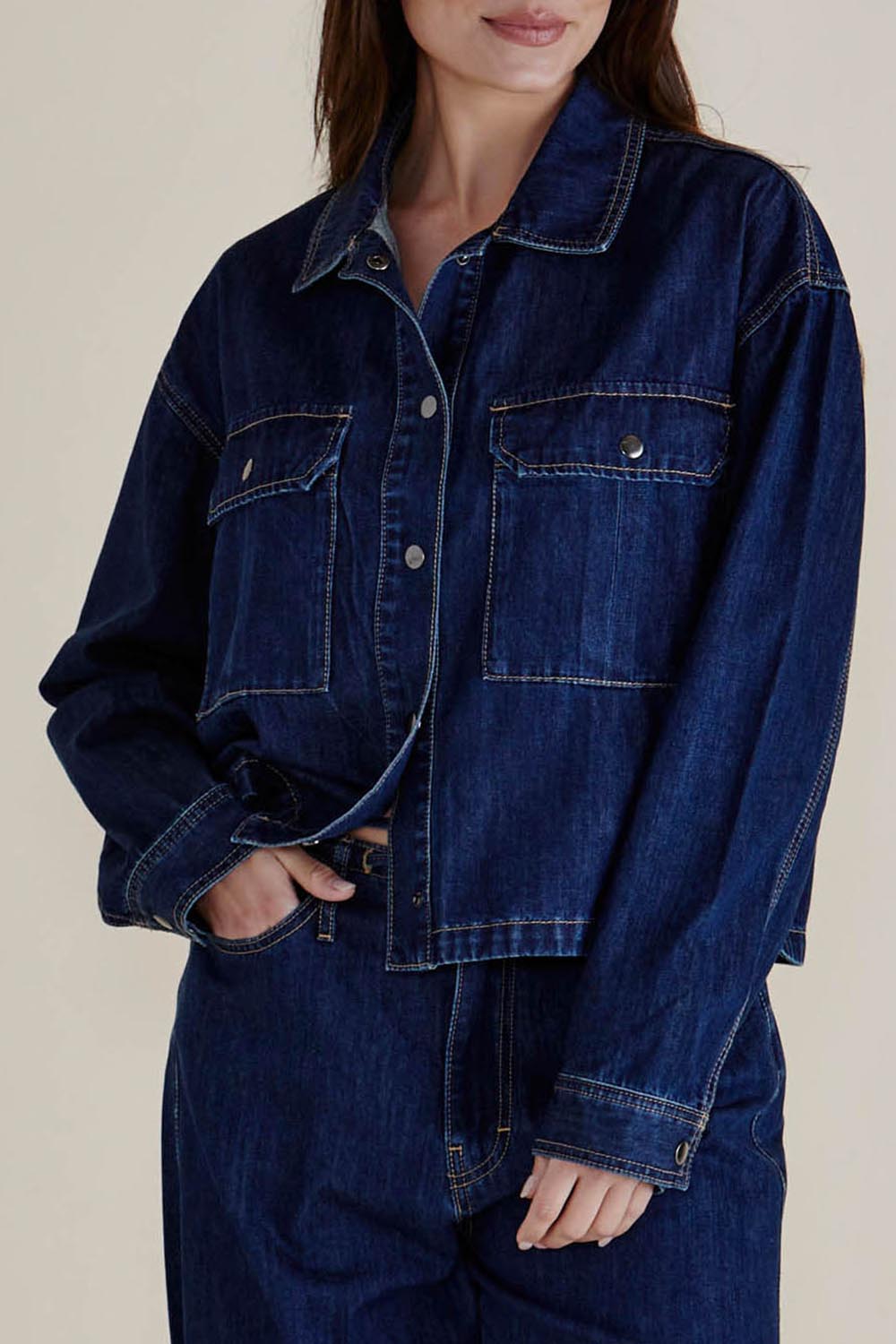 A model wearing the Selby Denim Jacket in colour Darkblue (Blue), from the front, cropped image