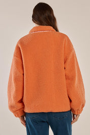 A model wearing the Jayne Fleece Jacket in colour Pinkorange (Pink), from the back