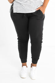 Model Alexis wearing size 16 of the Max Jogger in colour Black (Black), from the front, cropped image