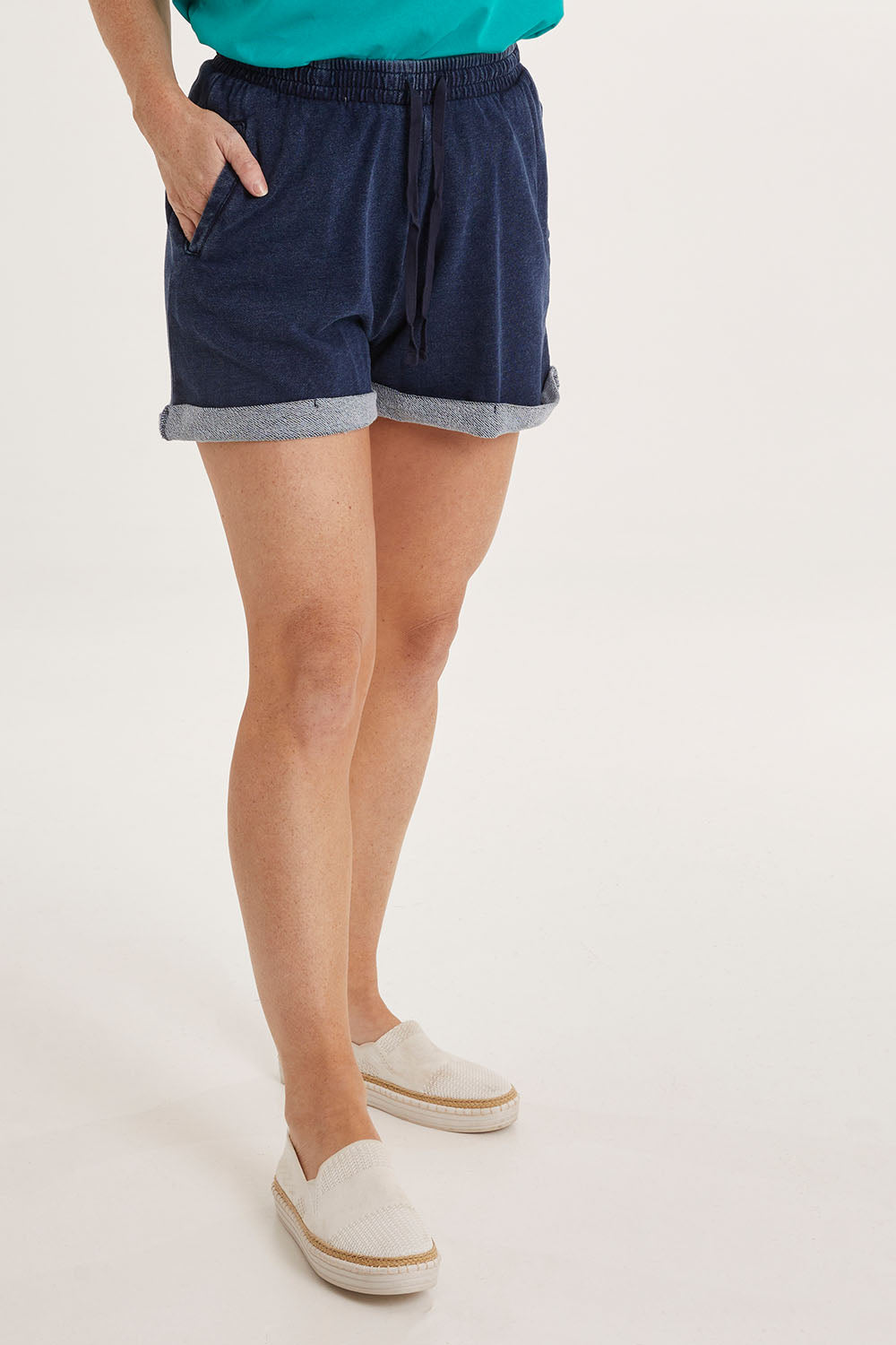Model Sally wearing size 10 of the Trixie Shorts in colour Indigowash (Blue), from the front, cropped image