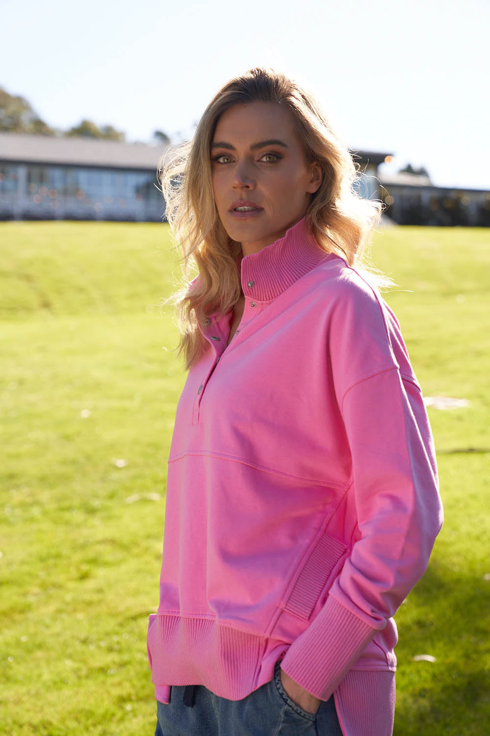 A model wearing the Sadie Sweat in colour Bpink (Pink), from the front, showing the whole outfit