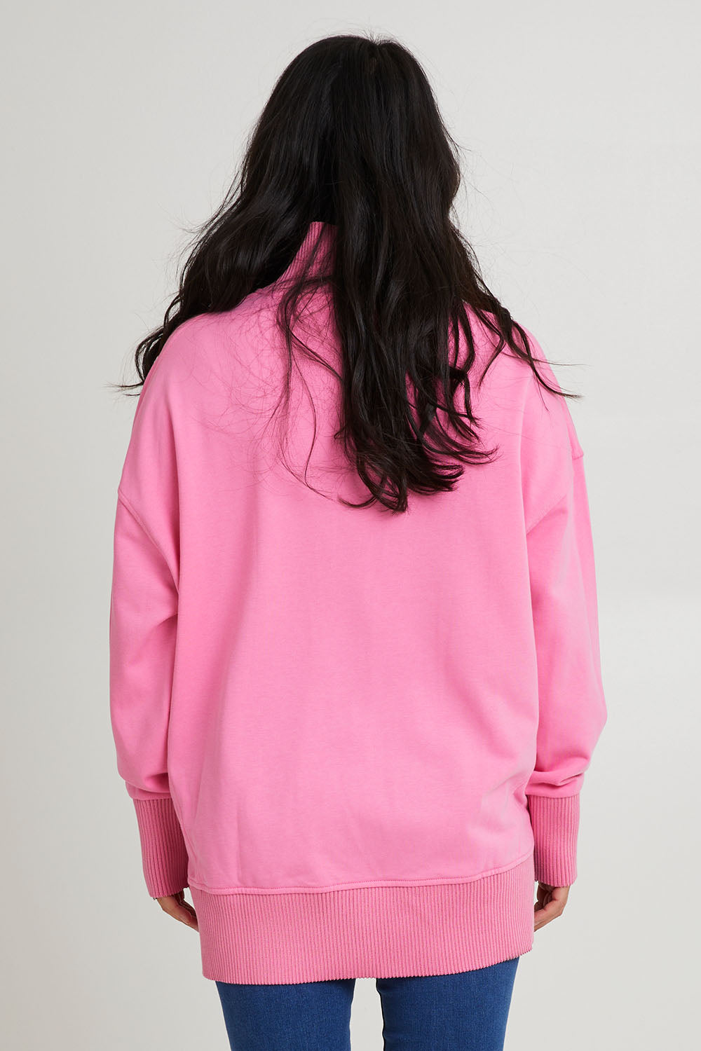 Model Katie wearing size 10 of the Sadie Sweat in colour Bpink (Pink), from the back