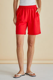 A model wearing the Harvard Cotton Short in colour Red (Red), from the front, cropped image