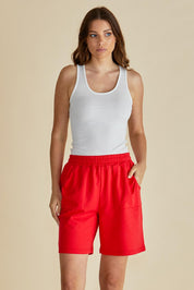 A model wearing the Harvard Cotton Short in colour Red (Red), from the front, cropped image