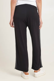 Model Madeline wearing size 10 of the Evelyn Wide Leg Jogger in colour Black (Black), from the back